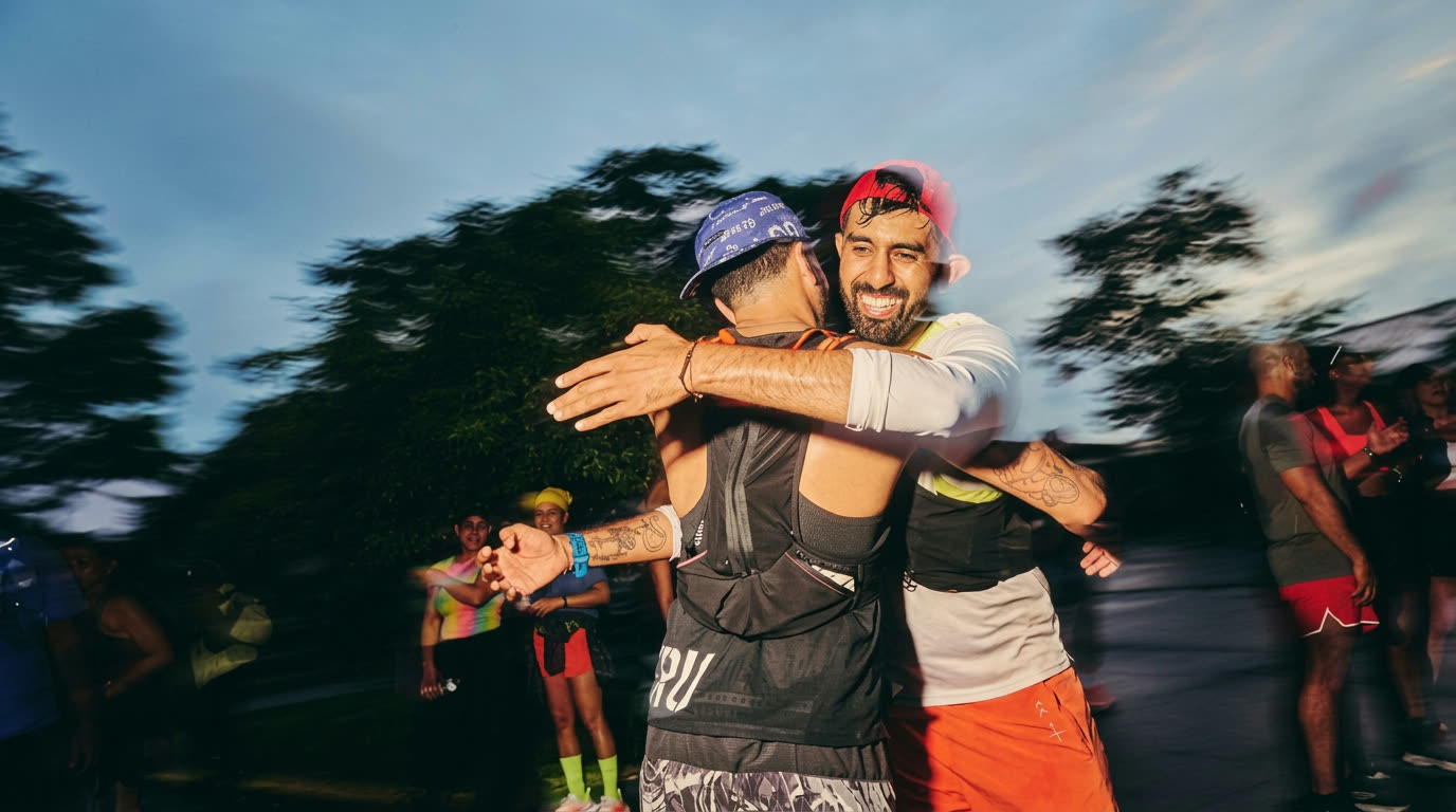 Two runners celebrating with a joyful hug after a race, surrounded by motion-blurred scenery